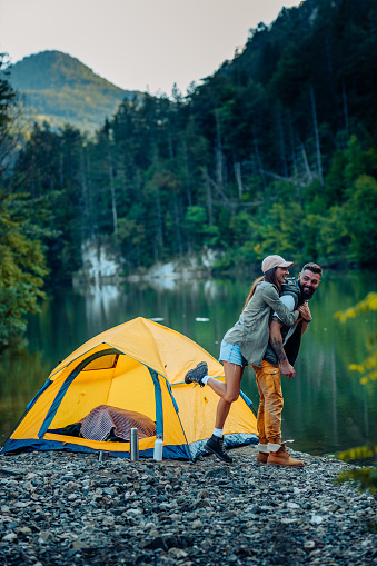 An attractive young couple spending the day in nature at campsite