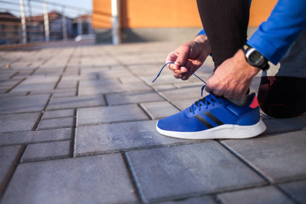 Close up Male jogger tying his shoe
