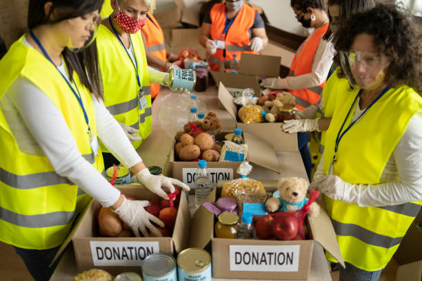 istock Volunteers assembling food for donation 1305326652