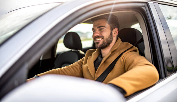 istock Happy man driving a car. 1305326717