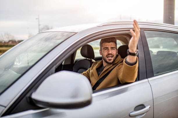 istock Frustrated driver arguing in traffic. 1305327299