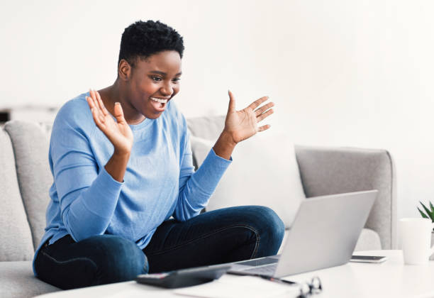 istock Black woman having video call using laptop and gesturing 1305327395