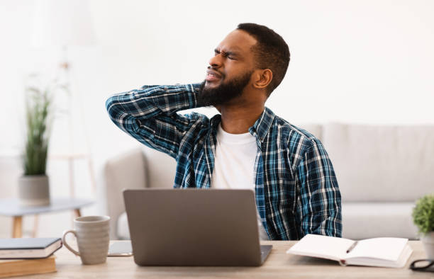 istock African Businessman Massaging Aching Neck Tired After Computer Work Indoor 1305327720