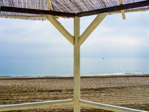 Wooden pergola from a beach bar facing a calm sea