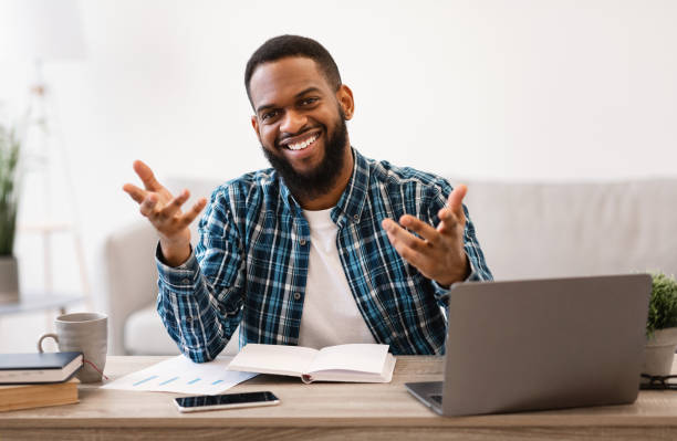 istock Positive African Business Guy Talking To Camera Sitting In Office 1305327936
