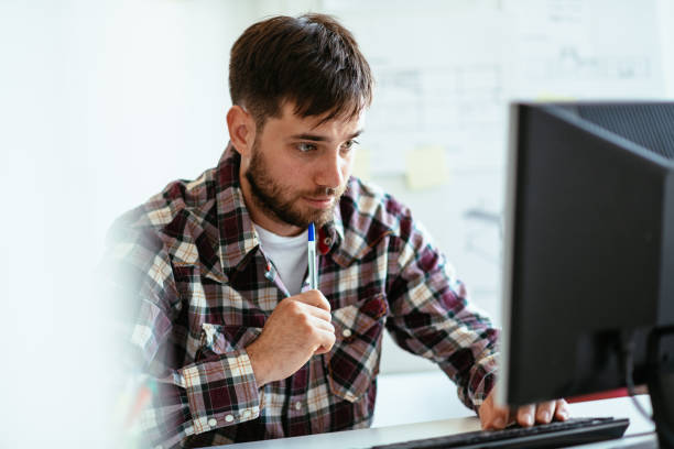 istock Contemplating entrepreneur working in office on desktop PC, using internet to apply for state aid COVID-19 finances 1305328016