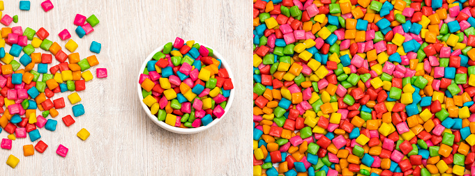 Colored chewing gum in the bowl - Wooden background