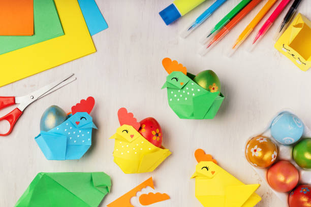 istock DIY paper crafts for the Easter holiday. Hobbies at home. Self-employment and needlework. Origami paper chicken - egg basket for Easter greetings. DIY concept. Step by step instruction, step 4. 1305329145