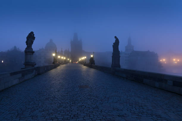 istock Empty Charles bridge, Prague during sunrise at a time of coronavirus lockdown, Czechia. No tourists,no guards. Famous travel destination during COVID-19 pandemic lockdown. 1305329178