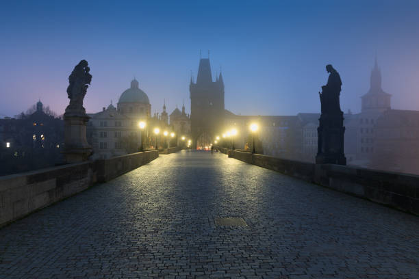 istock Empty Charles bridge, Prague during sunrise at a time of coronavirus lockdown, Czechia. No tourists,no guards. Famous travel destination during COVID-19 pandemic lockdown. 1305329254