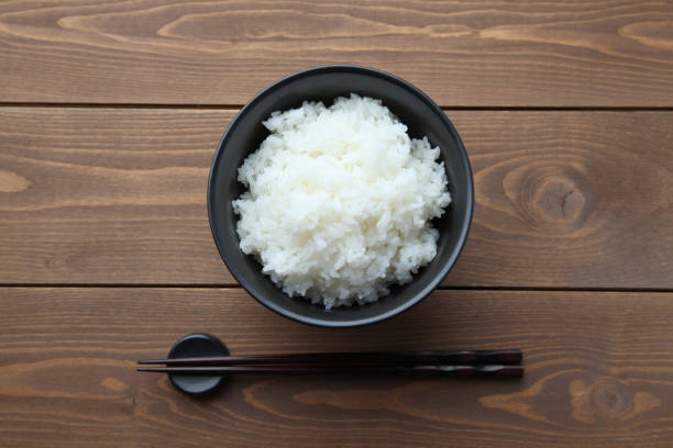 istock plain white rice in bowl with chopsticks isolated on table 1305329319