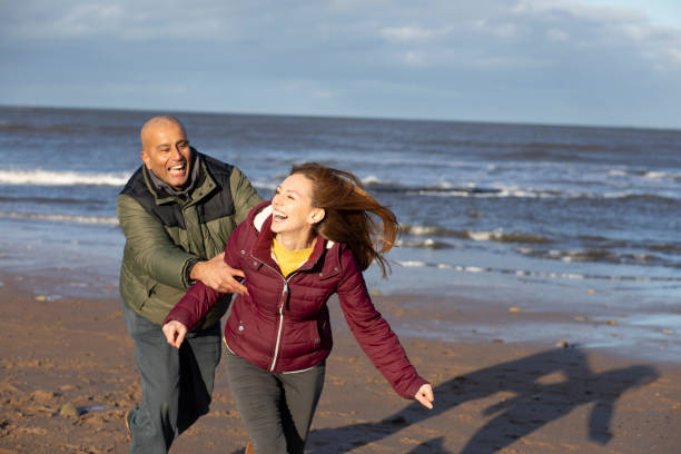 istock Couple Playing on the Beach 1305329364