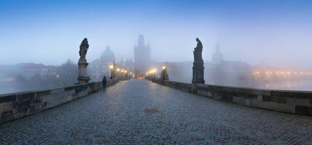 istock Empty Charles bridge, Prague during sunrise at a time of coronavirus lockdown, Czechia. No tourists,no guards. Famous travel destination during COVID-19 pandemic lockdown. 1305329434