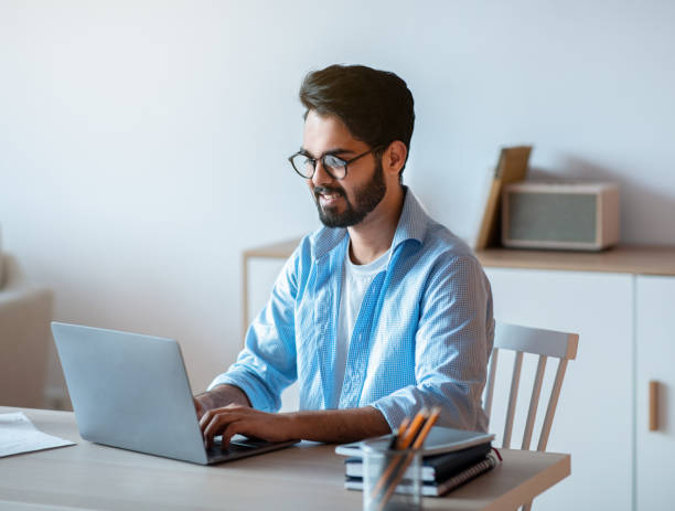 istock Millennial arab freelancer man working online on laptop at home office 1305329550