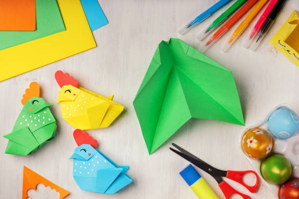 istock DIY paper crafts for the Easter holiday. Hobbies at home. Self-employment and needlework. Origami paper chicken - egg basket for Easter greetings. DIY concept. Step by step instruction, step 2. 1305329564