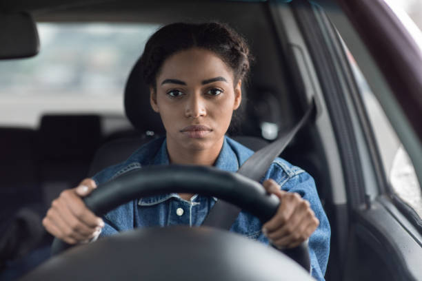 Traffic jams, routine commute, problems and tired driver Traffic jams, routine commute, problems and tired driver. Sad sick upset millennial african american lady holds steering wheel and looks out windshield and waiting of motion on way, copy space traffic jam stock pictures, royalty-free photos & images