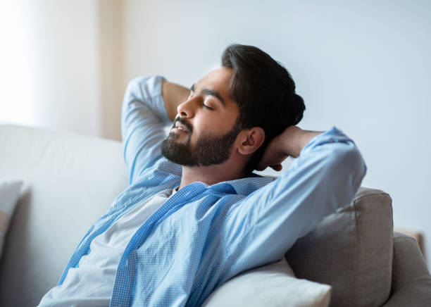 istock Relax Time. Handsome Arab Man Leaning Back On Couch With Closed Eyes 1305331037