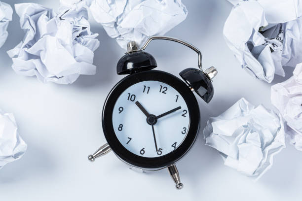 istock Alarm clock with crumpled paper balls.Timing and thinking idea concept. 1305331707