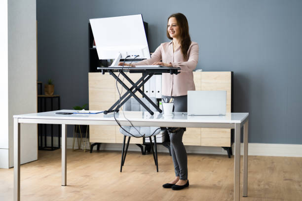 istock Adjustable Height Desk Stand In Office 1305331953