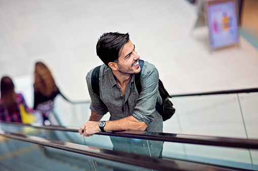 Portrait of man standing on an escalator in the Mall