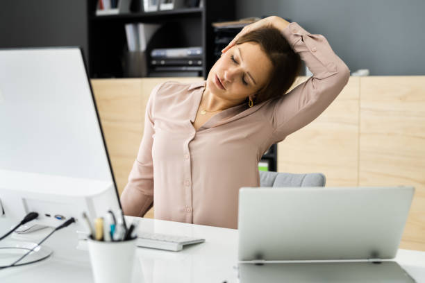 istock Woman Stretching At Office Desk 1305332139