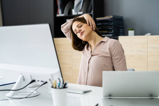 istock Woman Stretching At Office Desk 1305332153