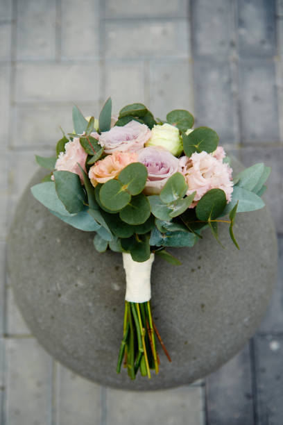 top view of bridal bouquet of pink, purple roses and greenery on stone background outdoors, copy space. wedding concept - small bouquet imagens e fotografias de stock