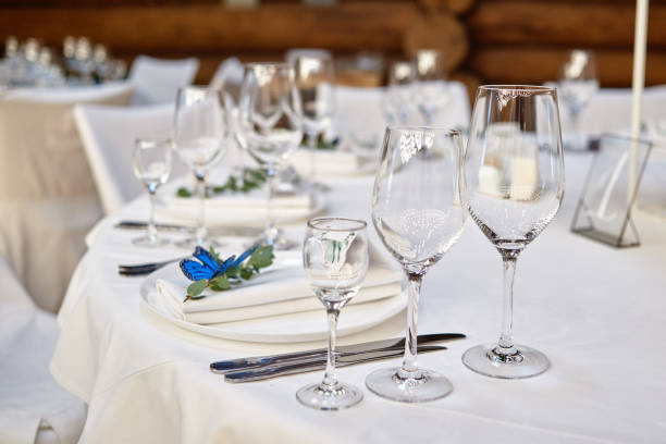istock Table setting with sparcling wineglasses and cutlery on table, copy space. Menu mockup, place setting at wedding reception. Table served for wedding banquet in restauran 1305332653