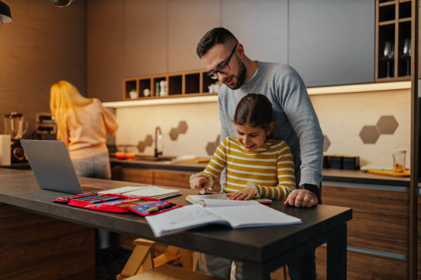 istock Dad and little daughter study at home 1305333759