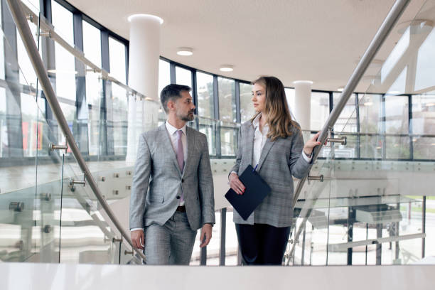 istock Two business colleagues are having conversation about work at their company 1305333792