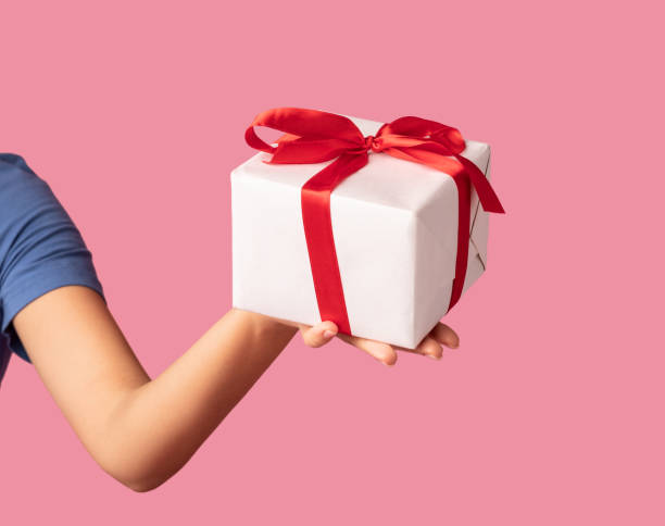 istock Unrecognizable lady holding and showing present box 1305333981