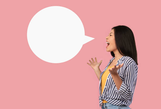 istock Emotional asian woman screaming at white speech bubble 1305334008