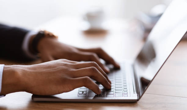 istock Male hands typing on laptop keyboard, cropped 1305334072