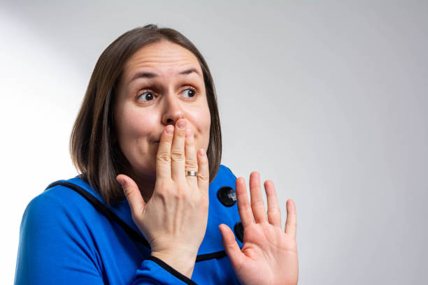 woman with hand over her mouth, surprised - gasping color image hands covering mouth staring imagens e fotografias de stock