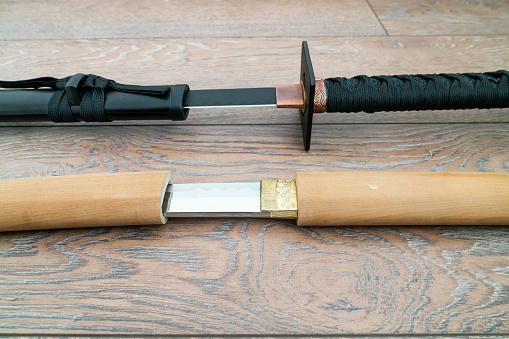Samurai and Ninja Sword on Wood Background