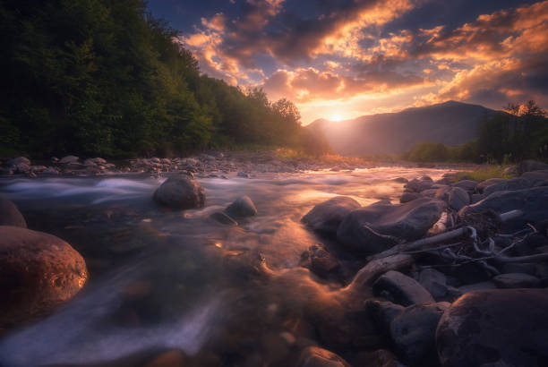 istock Magical sunset over fast flowing mountain river 1305336213