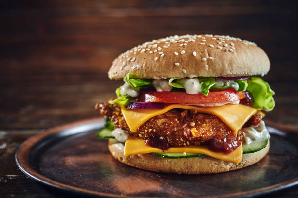 istock Crispy Chicken Burger with Cheese, Tomato, Onions and Lettuce 1305337802
