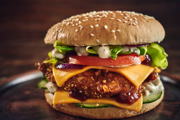 istock Crispy Chicken Burger with Cheese, Tomato, Onions and Lettuce 1305337803