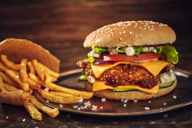 istock Crispy Chicken Burger with Cheese, Tomato, Onions and Lettuce 1305337848