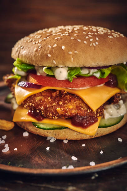 istock Crispy Chicken Burger with Cheese, Tomato, Onions and Lettuce 1305337887