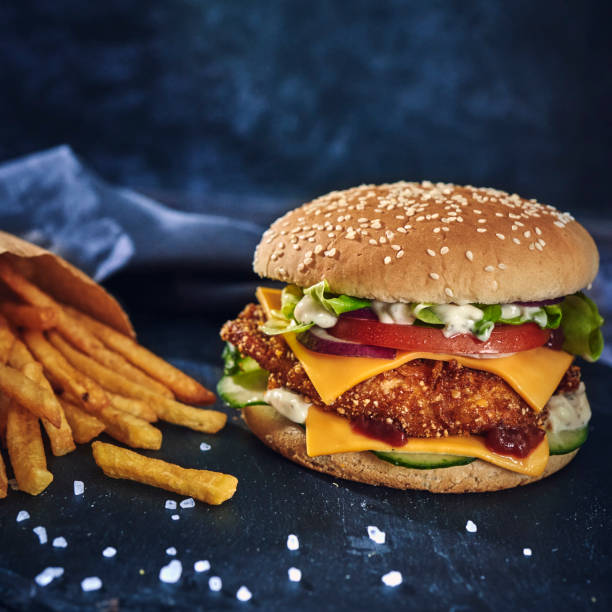 istock Crispy Chicken Burger with Cheese, Tomato, Onions and Lettuce 1305337944