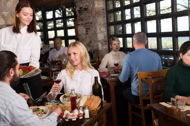 istock Waitress bringing meals to visitors 1305338114