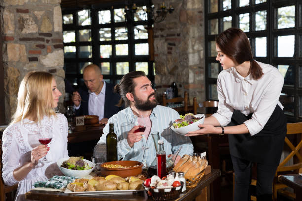 istock Happy people having dinner at rural restaurant and drinking wine 1305338119