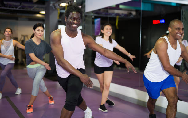 istock Group of people practicing together in gym 1305339540