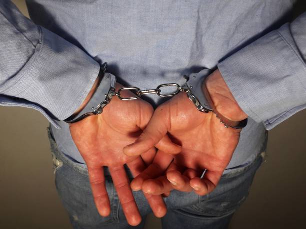 istock Handcuffs on arrested businessman hand 1305340568