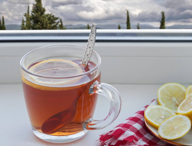 istock A Cup of tea and a lemon on the window sill 1305341485