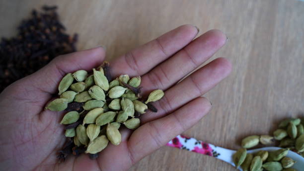 istock Dry cardamom seeds in man palm 1305342457
