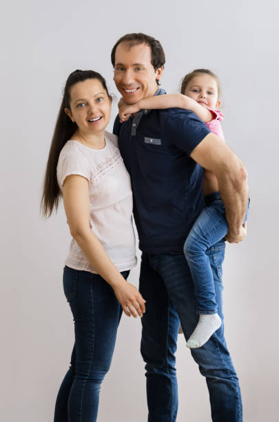 istock Happy Young Family Standing 1305342755