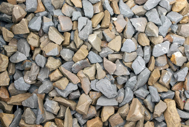 istock Natural chipped stone background. Natural gray granite chips, crushed stone or crushed stone texture, top view 1305343034