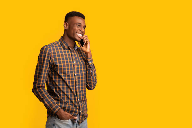 istock Mobile Communication. Positive African American Guy Talking On Cellphone And Looking Away 1305343262
